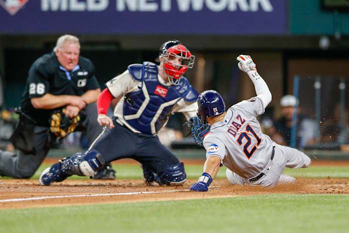 Jun 30, 2023; Arlington, Texas, USA; Houston Astros catcher Yainer Diaz (21) slides home safely under the tag by Texas Rangers catcher Jonah Heim (28) during the sixth inning at Globe Life Field. Mandatory Credit: Andrew Dieb-USA TODAY Sports